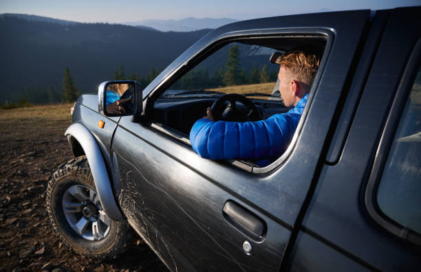 istock Off-road riding on black SUV in the mountains. 1313227111