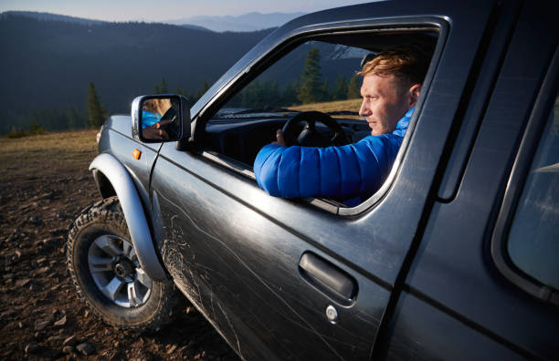 Off-road riding on black SUV in the mountains.