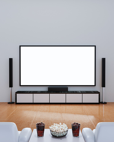 Home Theater on white plaster wall. Big wall screen TV and  Audio equipment use for Mini Home Theater. white sofa table on wooden floor. Cola and ice cube in clear glass with popcorn. 3D Rendering.