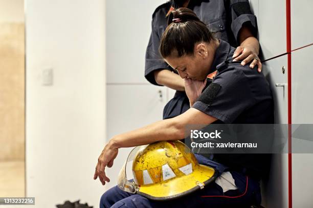 Teammate Consoling Exhausted Female Firefighter Stock Photo - Download Image Now - Emergency Services Occupation, Firefighter, Mental Health