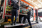 Firefighters Organizing Fire Engine Storage Compartments