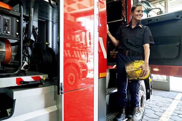 Portrait of Late 30s Female Firefighter Boarding Fire Engine