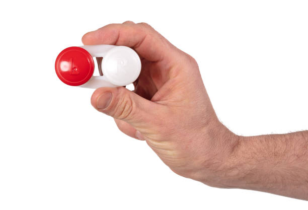 istock Man hand is holding contact lens case, isolated on white 1313233396