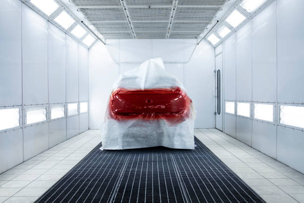 Freshly painted car drying in auto repair shop. Freshly painted car drying in auto repair shop. body paint stock pictures, royalty-free photos & images