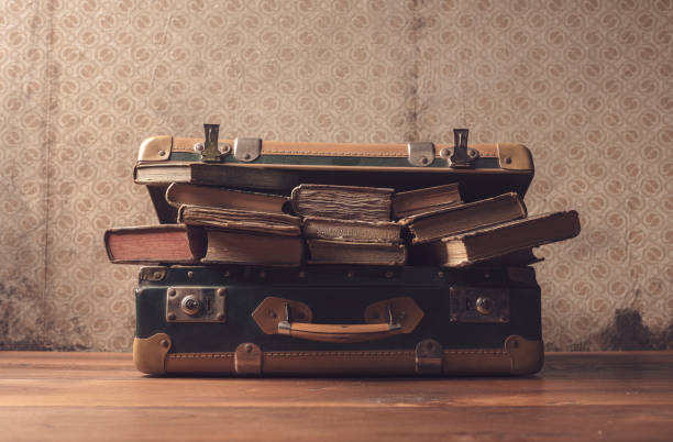istock Vintage suitcase full of old books 1313236878