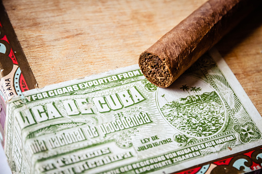 Cigars on vintage wooden box with Cuban official tax label