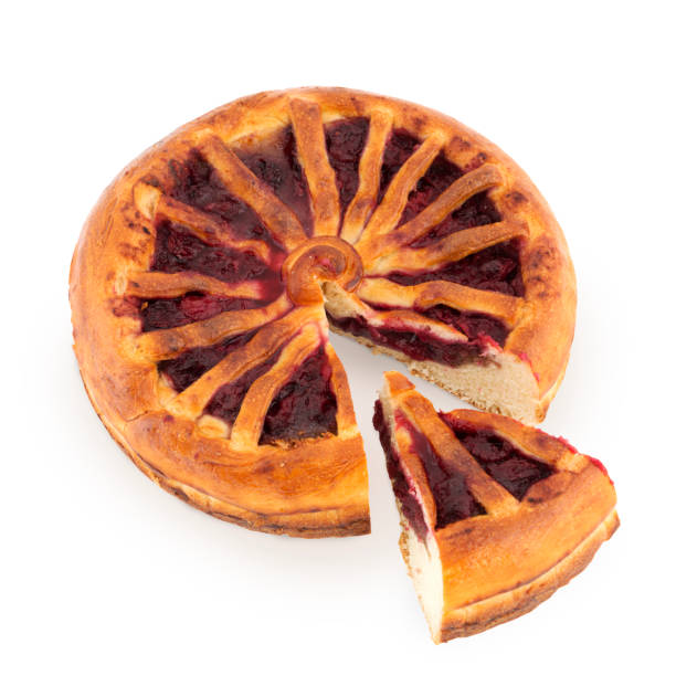 istock Round pie with fruit jam filling and sliced piece isolated on white 1313239869