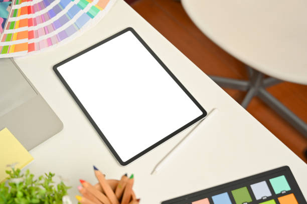 istock Designer workspace with digital tablets, coloured pencils and colour swatch on white desk 1313240074