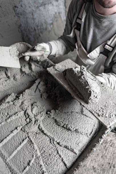 istock Real construction worker working on a wall inside the new house. 1313240620