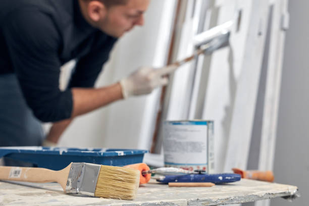 Young adult man painting on a DIY budget renovation of his new home apartment. Young adult man painting on a DIY budget renovation of his new home apartment. hobbyist stock pictures, royalty-free photos & images