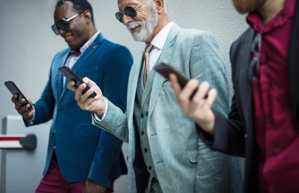 istock Business men on street using mobile. Focus is on background. 1313241028