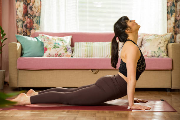 istock Young beautiful woman practicing yoga at home 1313241774