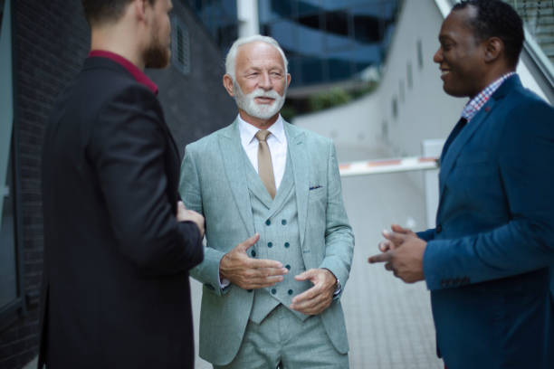 istock Business talk. Three business men talking. Focus is on background. 1313242022