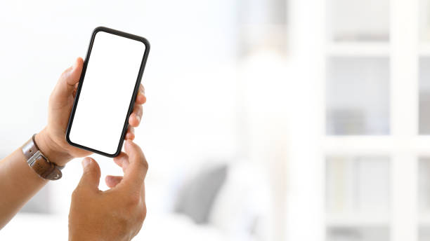 istock Hand man holding blank screen mock up smartphone with blurred background 1313242258