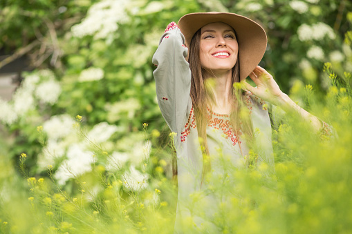 Beautiful summer woman in the field in green scenery