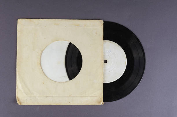 istock Old paper wrapped vinyl record on gray background. 1313246925