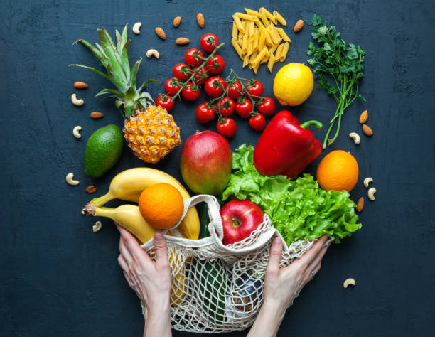 istock Hands holding a string bag with vegetarian food 1313247059