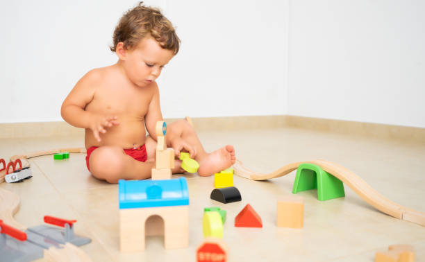 istock Child making structures with wooden toys. 1313249301