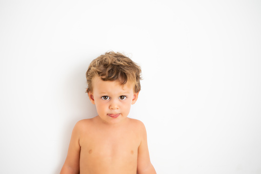 Photography of a caucasian child on white background. Copy Space.