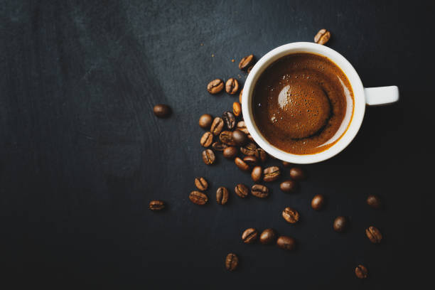 istock Tasty steaming espresso in cup with coffee beans. View from above. 1313249374
