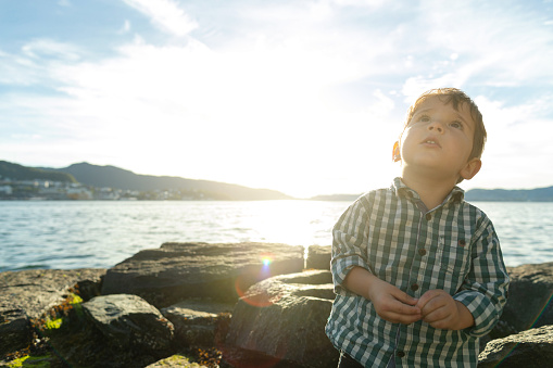 Cute little boy portrait during a warm summer sunset