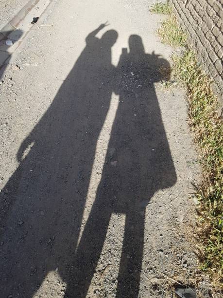 istock shadows of a two people - sisters - bff - friends 1313249487