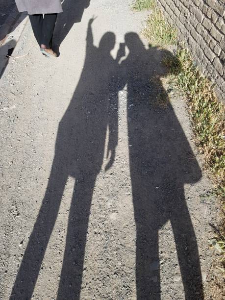 istock shadows of a two people - sisters - bff - friends 1313249493