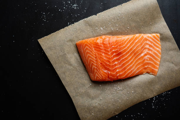 istock Raw salmon with spices on dark background 1313250402