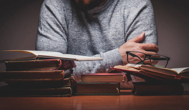 istock Man with Old Books in a Reading Room 1313250586