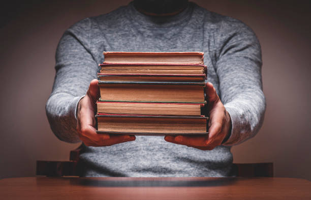 istock Man with Old Books in a Reading Room 1313250626