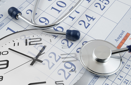 Regular medical examination concept, stethoscope on calendar and clock