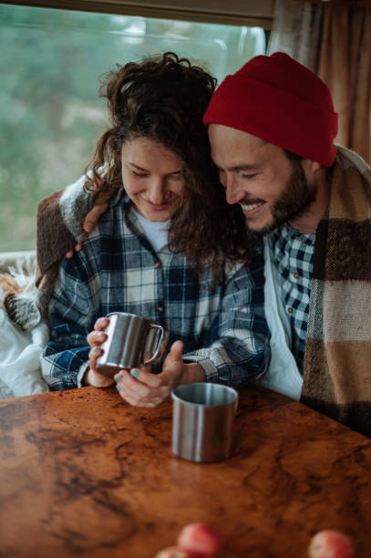 istock Couple sitting at a table in a motorhome and drinking tea. 1313256895