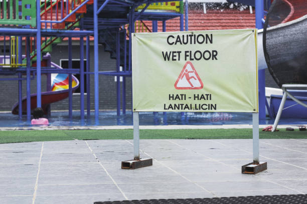 istock wet floor sign on the swimming pool 1313257402