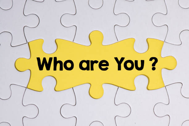 istock Who are you? Puzzle pieces on yellow background. 1313258194