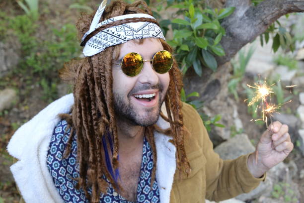 istock Young bohemian man celebrating with sparklers 1313258659