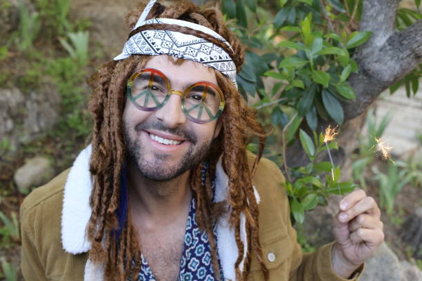 istock Young bohemian man celebrating with sparklers 1313258713