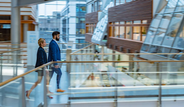 istock Business persons walking in the hall 1313261144