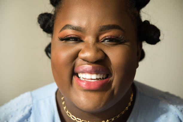 istock Female with vivid makeup laughing out loud while posing in front of the camera 1313261655