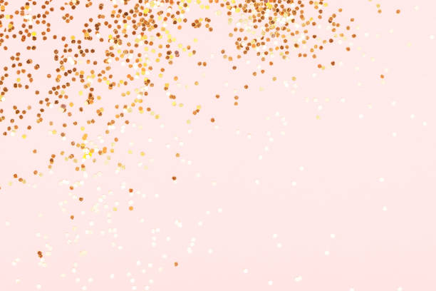 istock Golden confetti on pink background. 1313261689