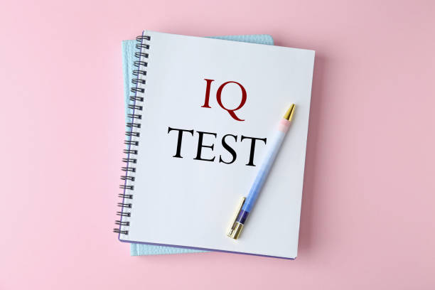 istock Notebook with text IQ Test and pen on pink background, top view 1313263527