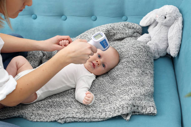 istock Sick baby. Temperature measurement in an infant. 1313263877