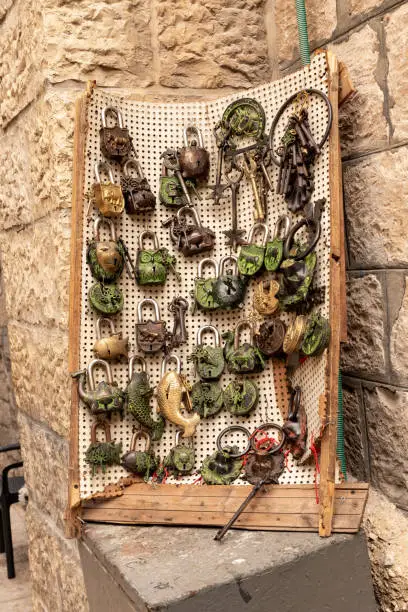 A stand with decorative locks for sale in a souvenir shop on the street in the Muslim quarter near the exit from the Temple Mount - Chain Gate, in the old city of Jerusalem, in Israel