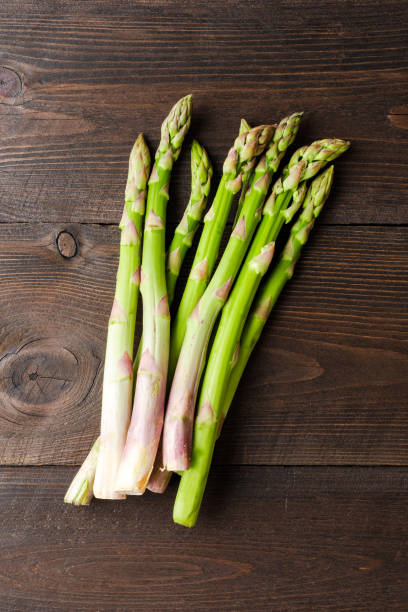 istock Asparagus on wooden table. Close up 1313265337