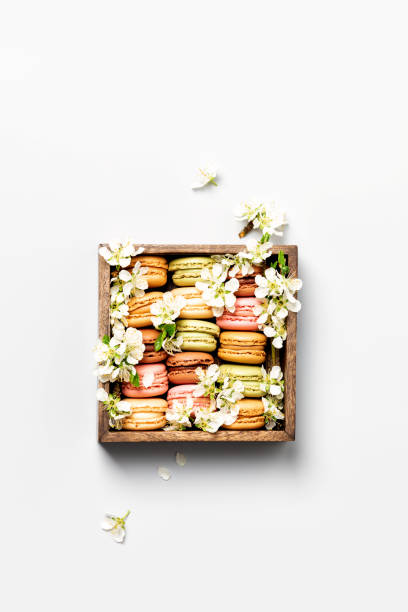 istock Macaroons in wooden box with spring flowers 1313265684