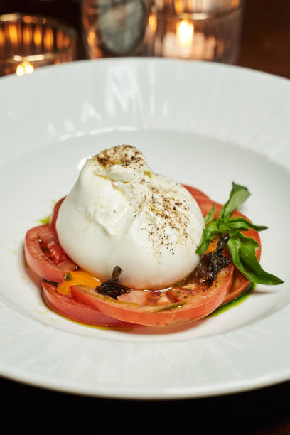 istock burrata cheese with tomatoes on a white plate 1313266778