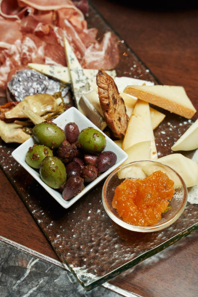 istock large olives in the foreground in focus on a plate with various appetizers 1313266911