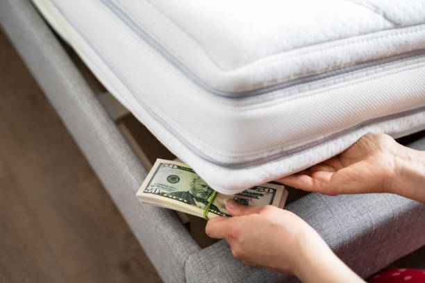 istock Saving Dollar Money Under Bed Mattress 1313267112