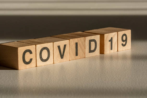 istock Covid-19 text on wood cubes. 1313268406
