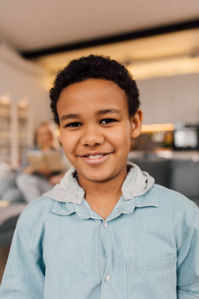 istock Boy looking at the camera with pleasure smile while spending time at home 1313269414