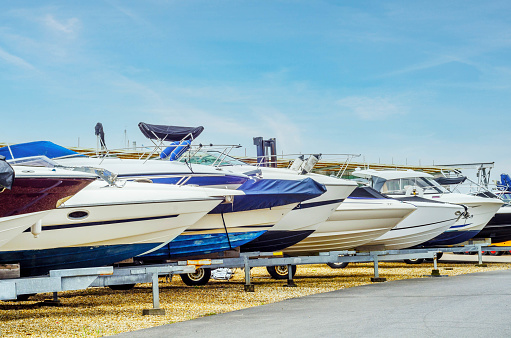 Boats on stand on the shore, luxury  yachts and ships, maintenance and parking place boat, sailing industry